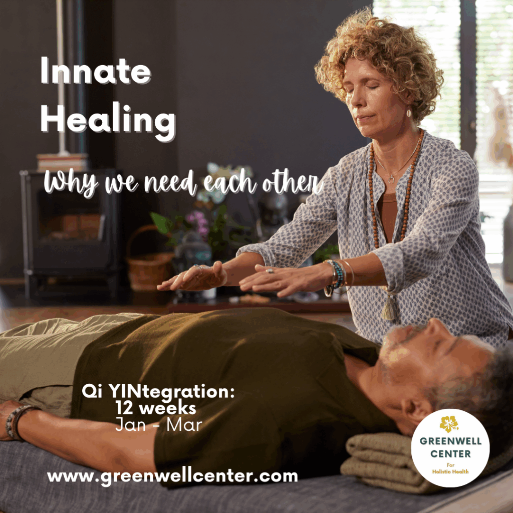 woman holding hands above the body of a man lying on a massage table