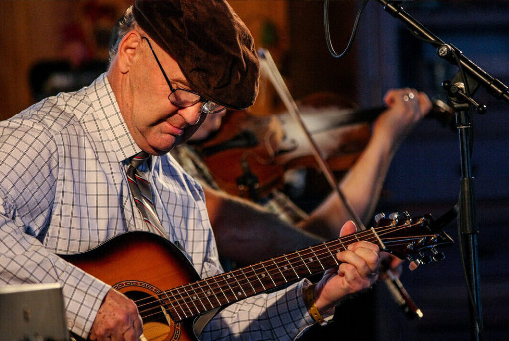 several pictures of a musician playing guitar and mandolin
