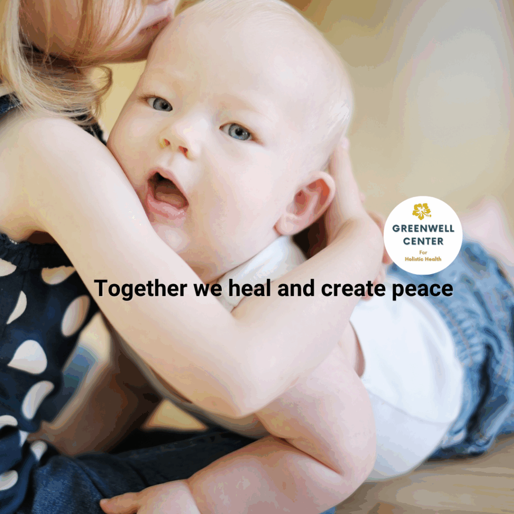 young baby being hugged by bigger sister