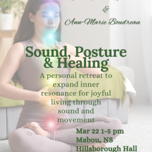 woman with legs crossed on carpet in front of bed, with chakra lights along the front of the body