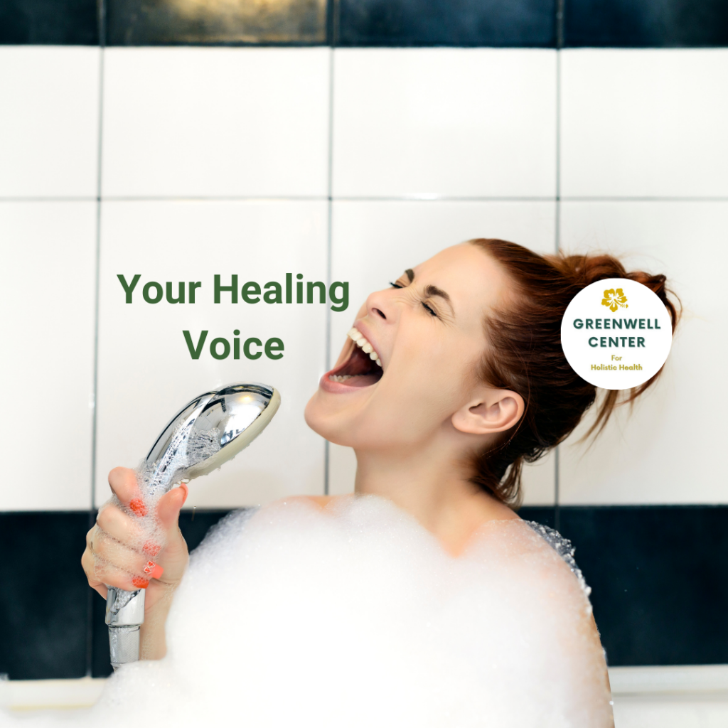 woman singing into the shower head in the bathtub