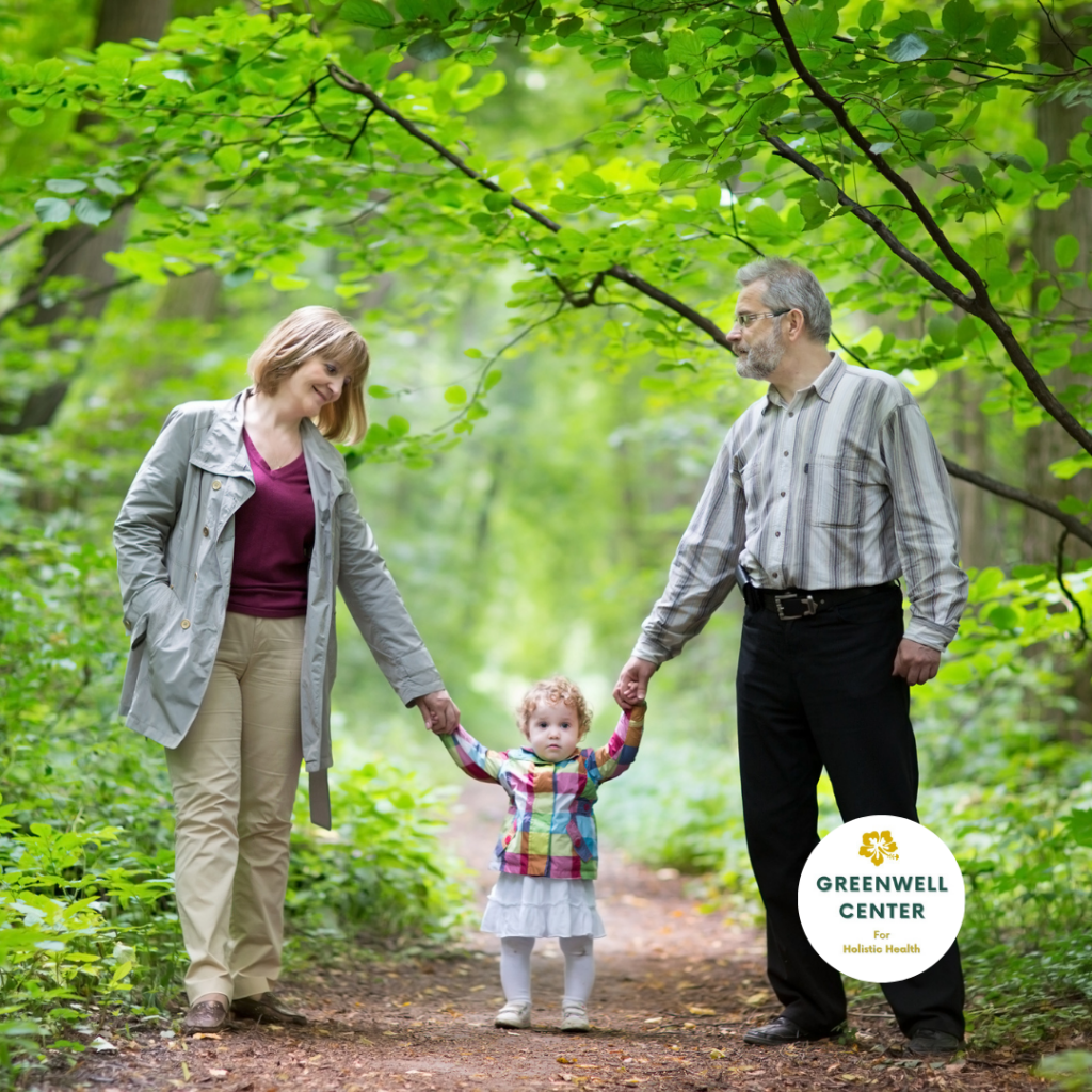 toddler walking and holding hands with mother and grandfather