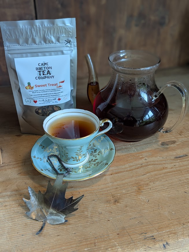 tea pot with tea, tea cup with tea, maple leaf in pewter, tea bag